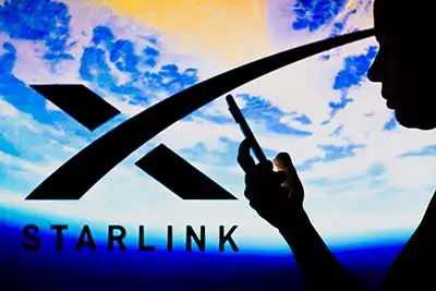 A Starlink logo with a woman holding a phone