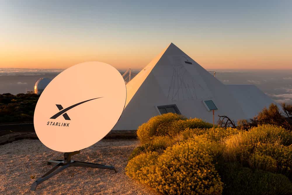 First gen Starlink satellite dish outside a tent