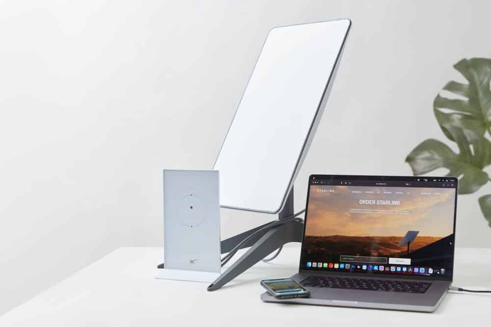 Starlink antenna, Wi-Fi router, and a laptop