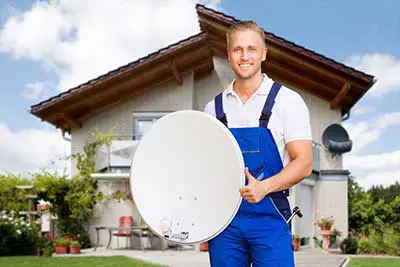 A man is holding a satellite dish.
