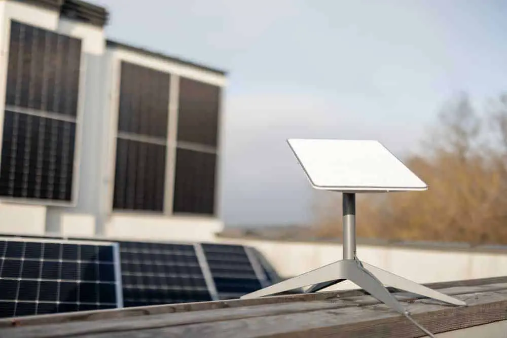 A Starlink rectangular dish next to a set of solar panels