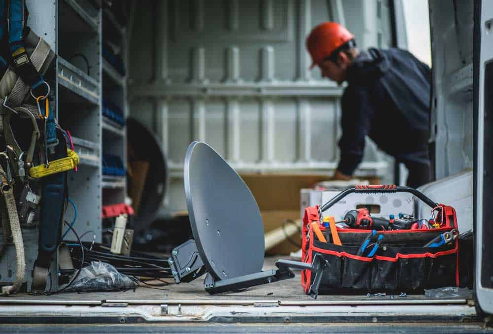 A technician assembling a dish.