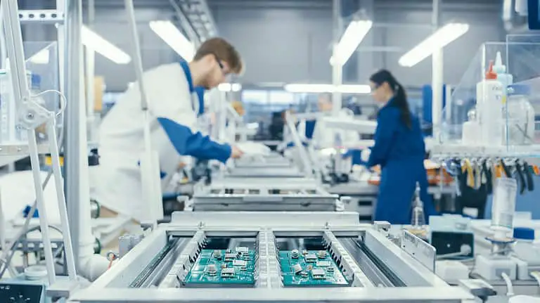Electronics Factory Workers Assembling Circuit Boards by Hand.