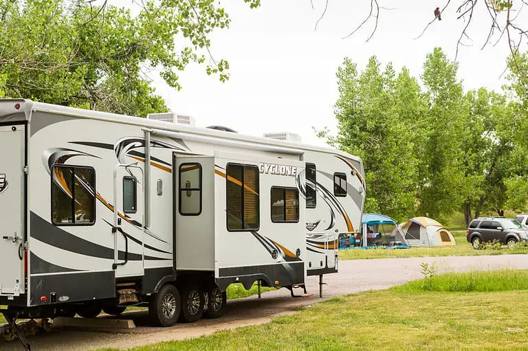 An RV camper on camping grounds.