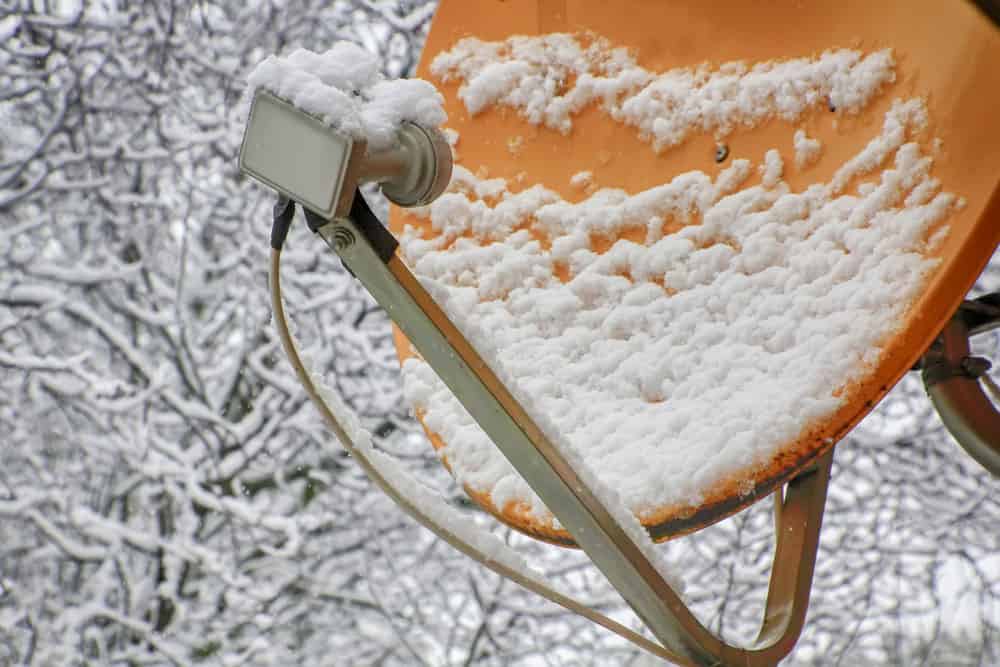 A satellite dish under snow.