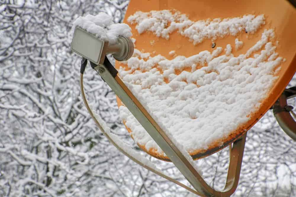 A satellite dish under snow. 