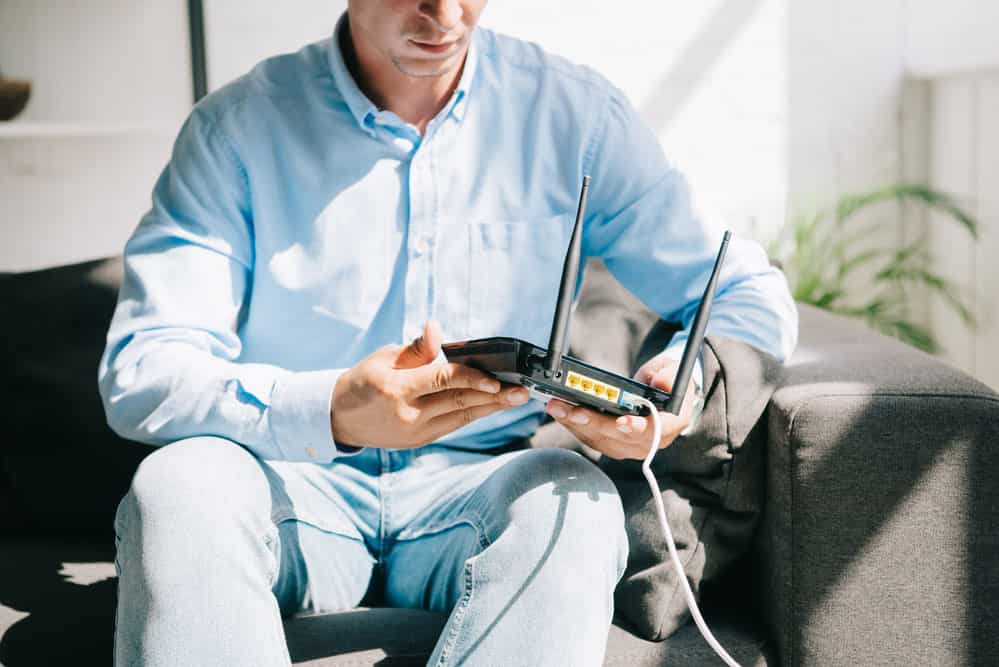 A technician with a modem router.