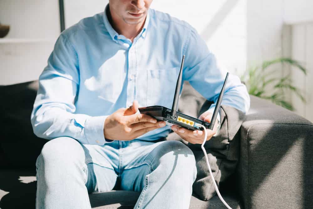 A technician with a modem router. 