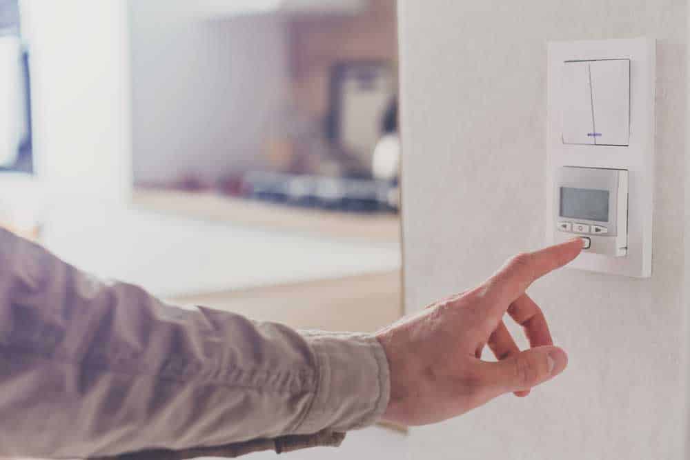 Man resetting thermostat in the home