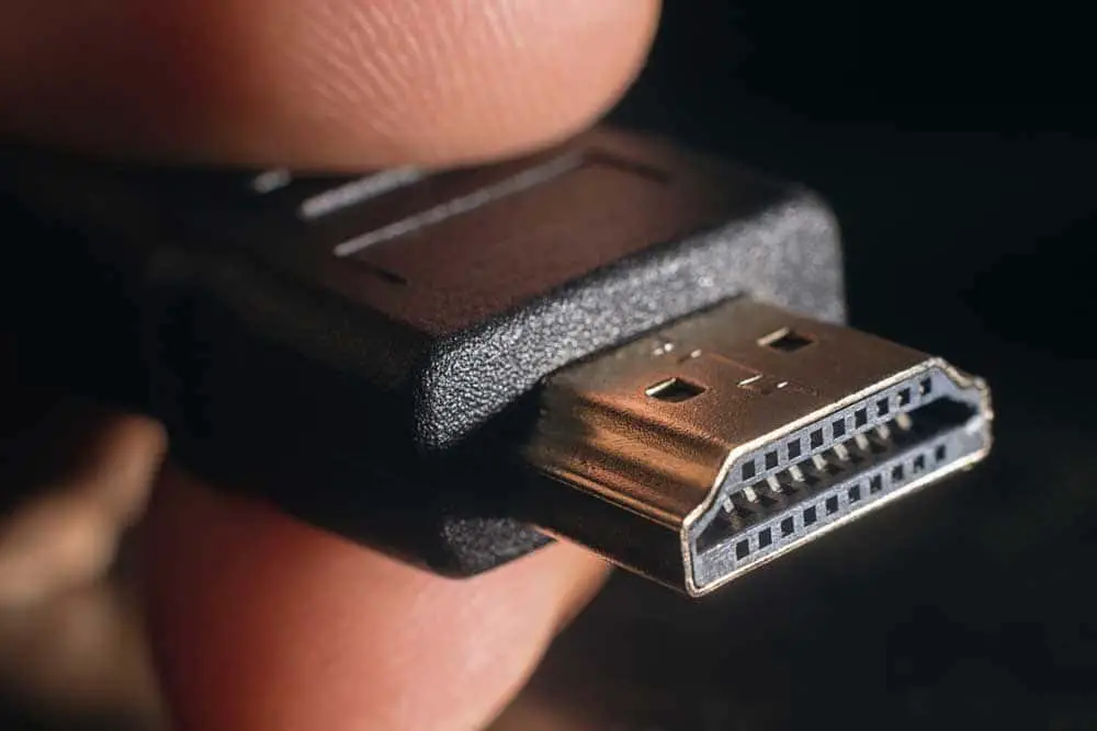 Hand-holding tip of HDMI cable 