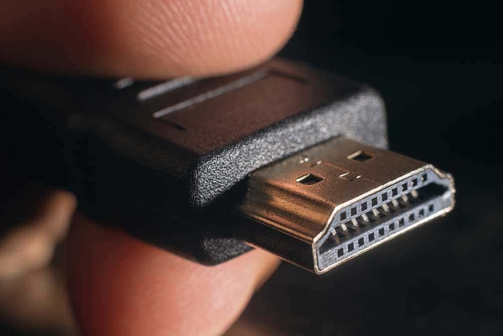 Hand-holding tip of HDMI cable 