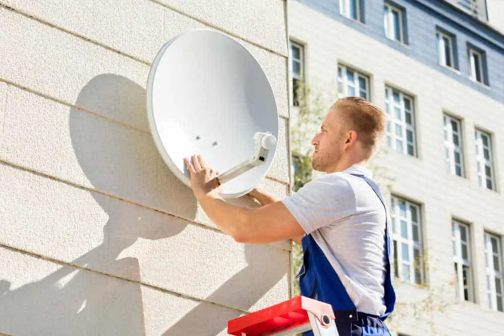 Man fixing an antenna TV dish