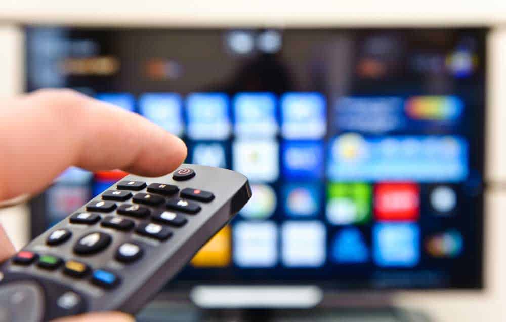 Adjusting a TV’s settings.